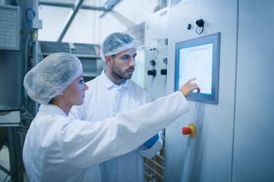Food technicians working together in a food processing plant-1