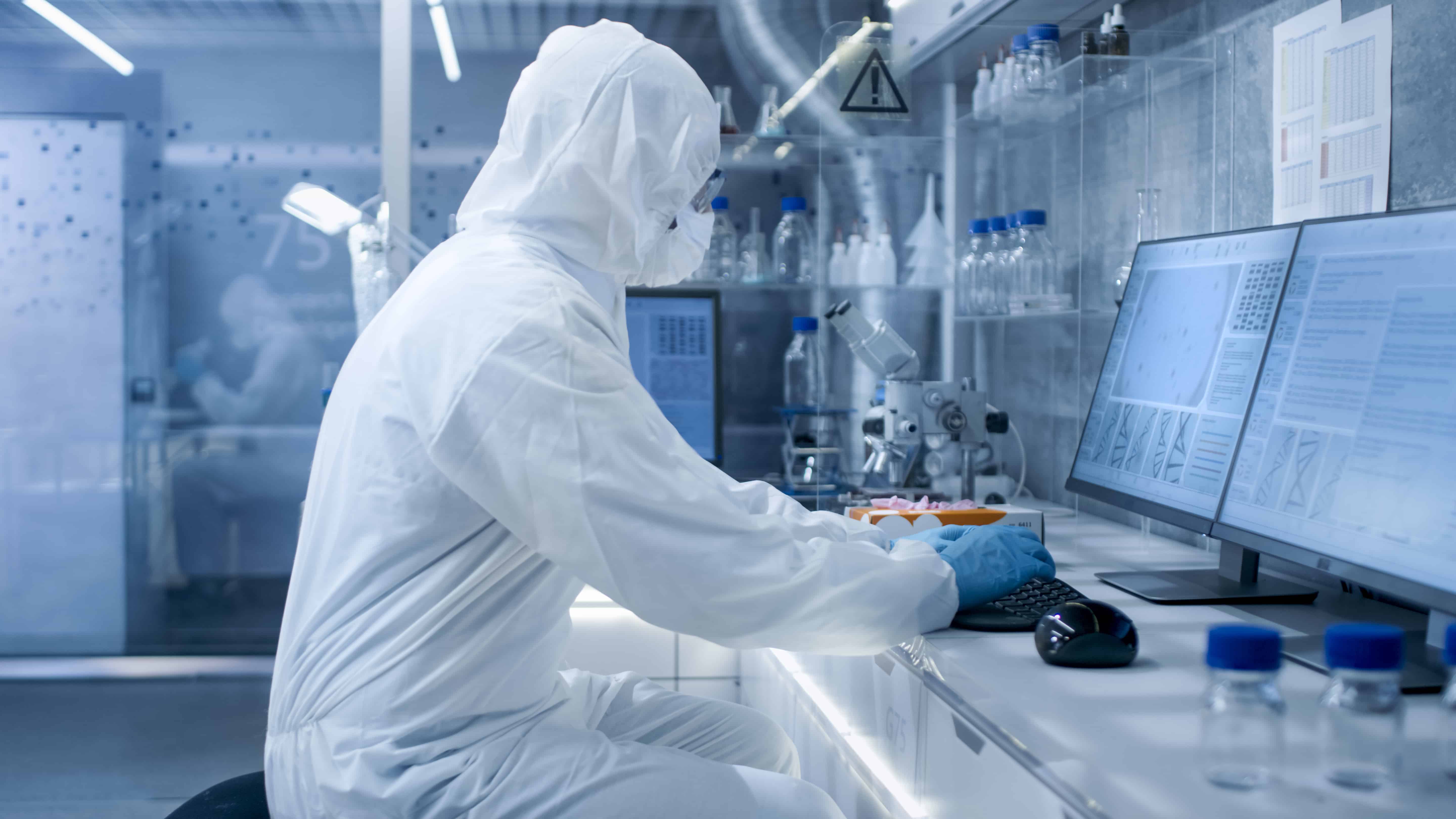 Scientist wearing PPE working in a cleanroom
